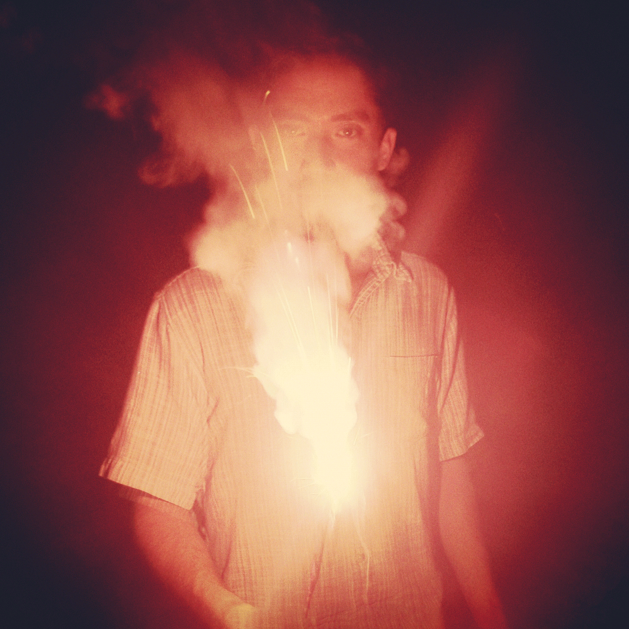 Evan Viera holding a sparkler in a dramatic black and white portrait